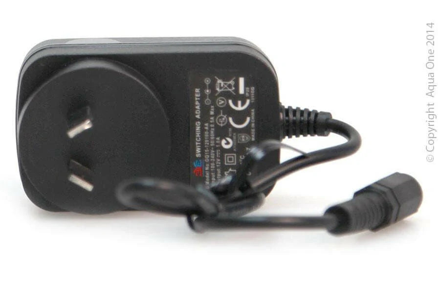 Black power adapter with plug on a white background