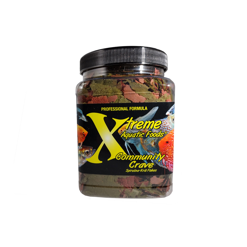 A clear container of Xtreme 98g Community Crave Flake fish food, showing the product name and description, alongside a label showing various fish.