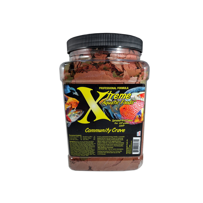 A clear container of Xtreme 227g Community Crave Flake fish food, showing the product name and description, alongside a label showing various fish.
